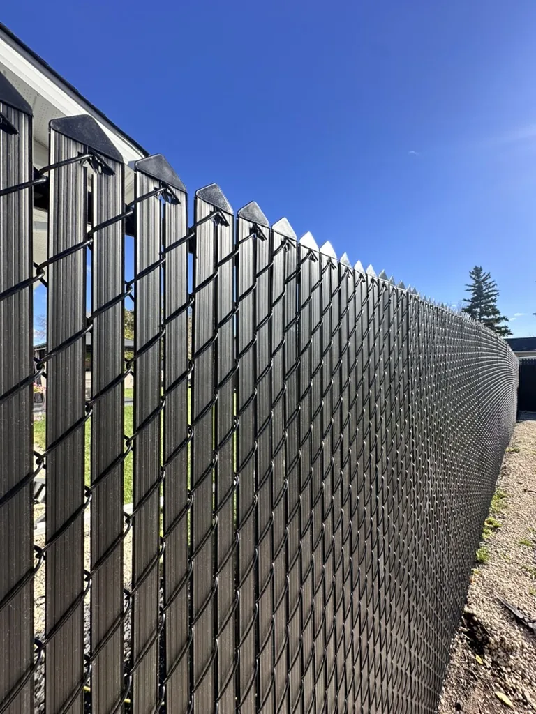 Chain link fence with privacy slat inserts closeup