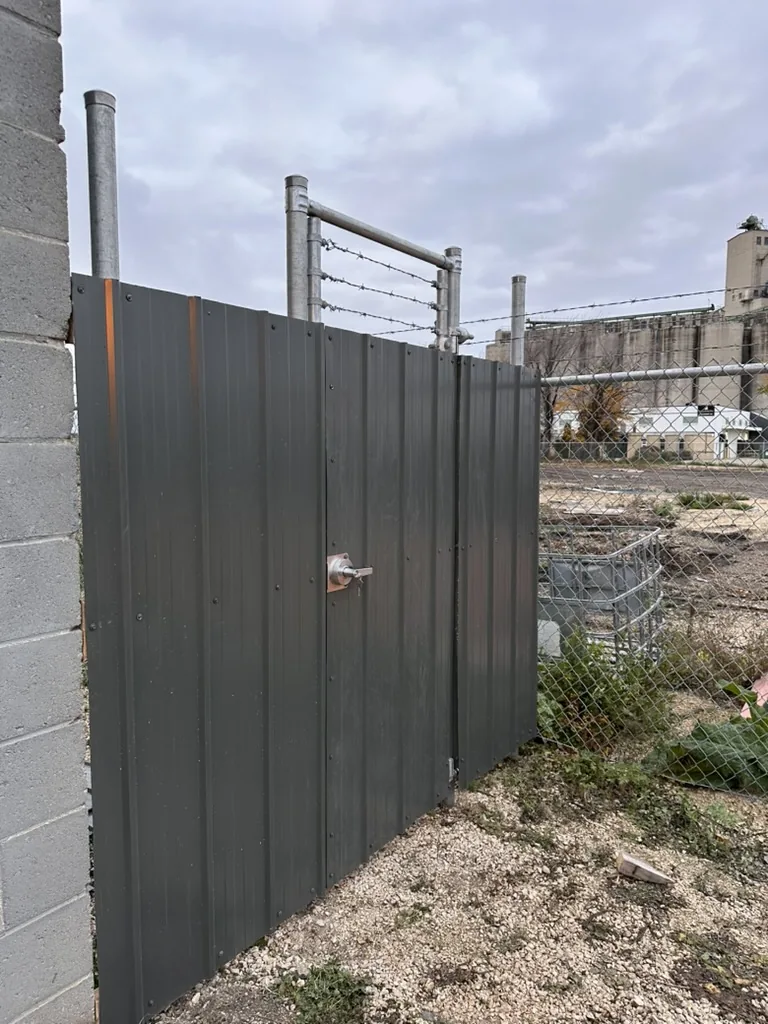 Commercial gate with barbed wire top