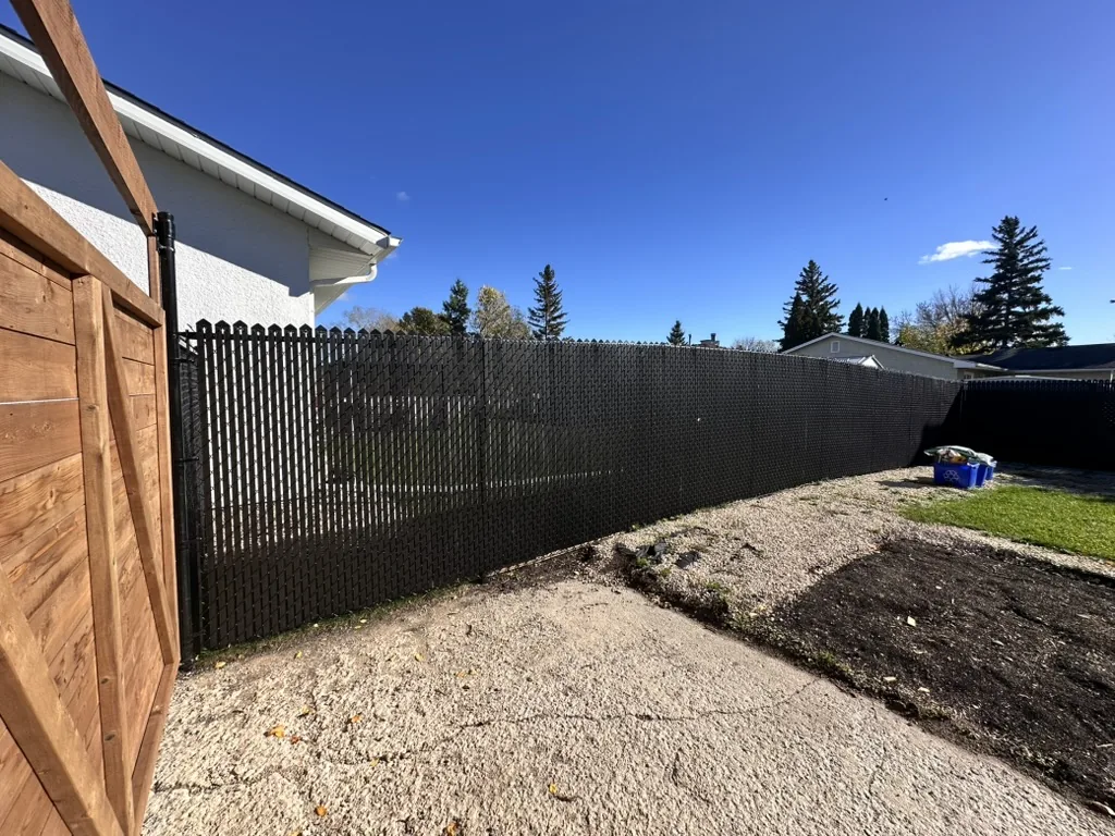 Black privacy slats on chain link in backyard
