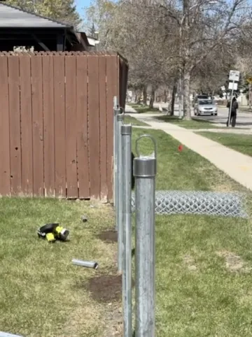 Board-on-board privacy fence along sidewalk