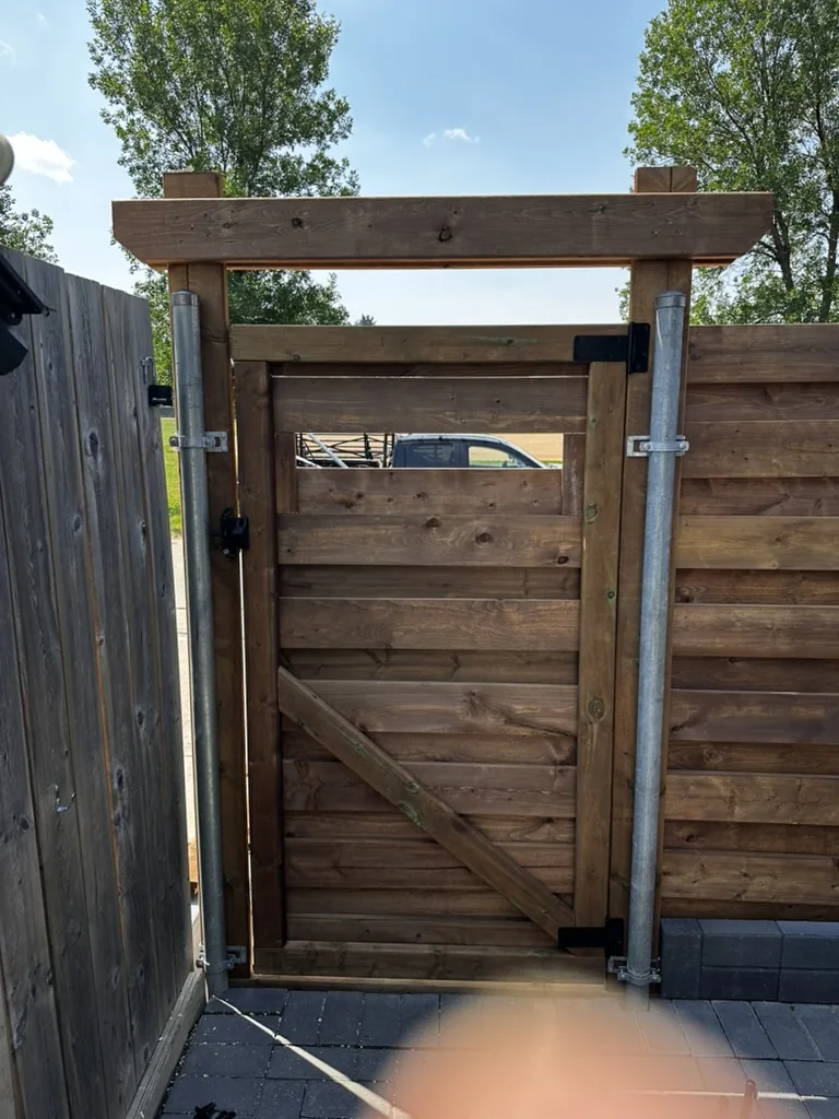 Cedar gate on galvanized posts with header beam