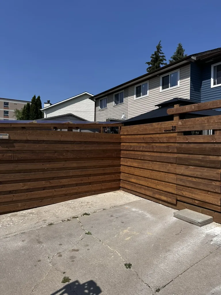 Horizontal cedar plank fence on steel posts